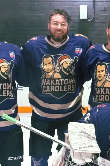 Robby smiling with teammates at the rink.